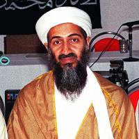 Trusted friend: Al-Qaida leader Osama bin Laden cradles a Kalashnikov in Afghanistan. | AFP-JIJI