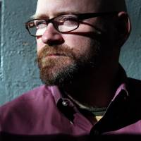 The dark side of privacy: Researcher Garth Bruen, shown Oct. 25 at his home office in Brookline, Massachusetts, works to track down people who run websites that promote pornographic violence. 'Privacy' services thwart investigation of rape video sites