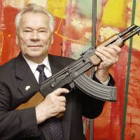 Accept no substitutes: Russian weapon designer Mikhail Kalashnikov presents his legendary assault rifle to the media while opening the exhibition \"Kalashnikov &#8212; legend and curse of a weapon\" at a museum in Suhl, Germany, in July 2002. Kalashnikov died Monday at age 94. | AP