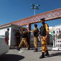 Vigilant: Yemeni security forces stand guard outside the Saudi German Hospital where a Japanese diplomat was taken for treatment after being stabbed during a failed abduction Sunday morning in the capital Sanaa. Japanese diplomat in Yemen stabbed in failed kidnap bid
