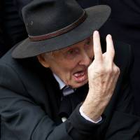 Mr. Bigg: Ronnie Biggs gestures on March 20 to waiting photographers as he arrives to attend the funeral of Bruce Reynolds, the mastermind of the 1963 Great Train Robbery, at Priory Church of Saint Bartholomew the Great in central London. Reports out of England on Wednesday said Biggs has died at age 84. 'Great Train Robber' Ronnie Biggs dies at 84