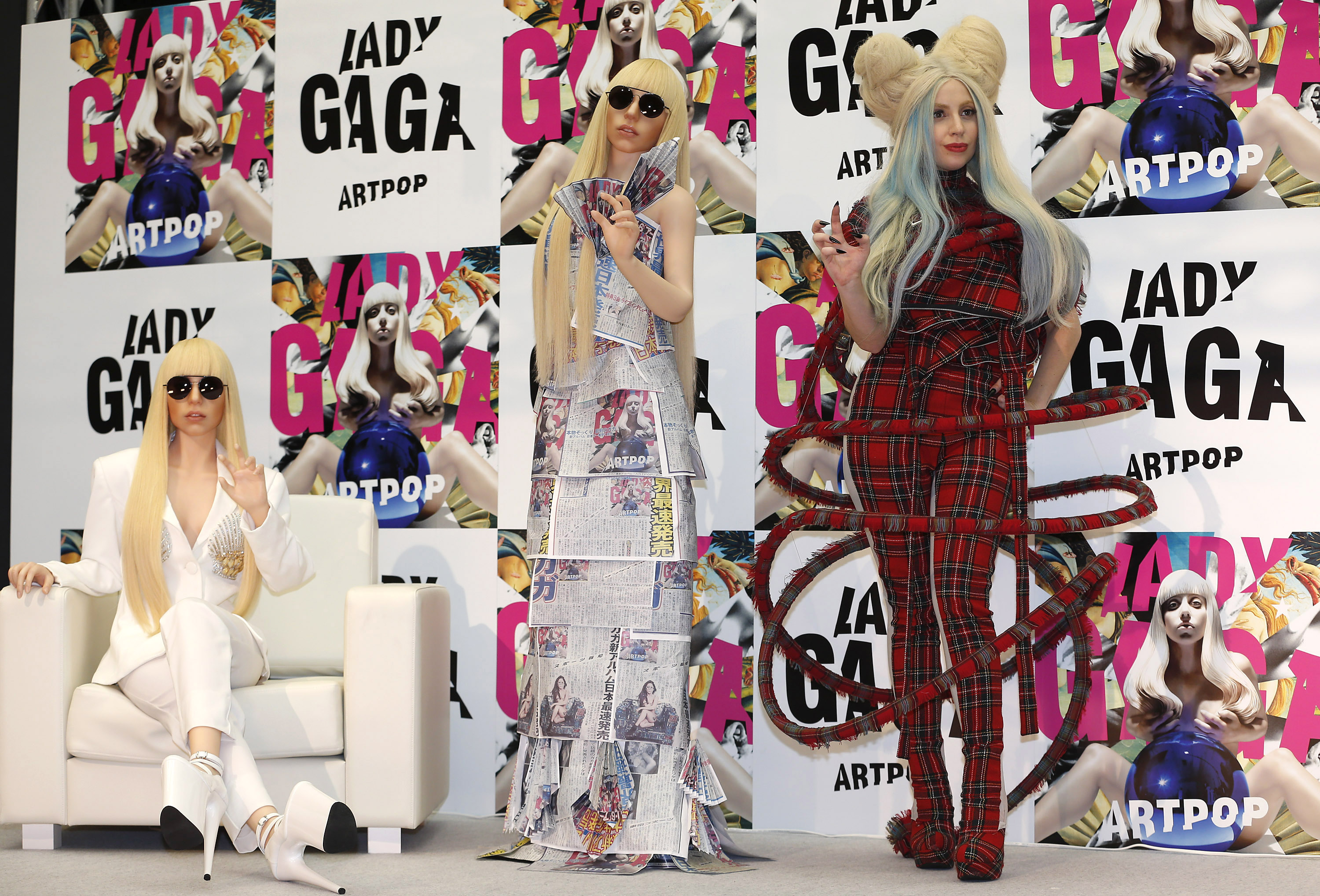 Pop art: Singer Lady Gaga poses for photographers with her life-size dolls during a news conference Sunday in Tokyo to promote her album 'Artpop.' | AP