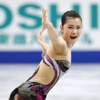Stirring performance: Kanako Murakami excites the crowd while skating to \"Violin Muse\" on Sunday in the short program at nationals at Saitama Super Arena. Murakami sits in third place heading into the free skate. | KYODO