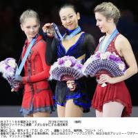 A reason for pride: Mao Asada (center) is joined by silver medalist Julia Lipnitskaia (left) and bronze medalist Ashley Wagner during the awards ceremony on Satuday night in Fukuoka. | KYODO