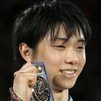 Proud moment: Yuzuru Hanyu displays his gold medal at the Grand Prix Final in Fukuoka.   | AP
