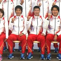 Relay the message: Japan national relay team members (from left) Chisato Fukushima, Ryota Yamagata, Yoshihide Kiryu and Shota Iizuka pose for a team photo on Monday. | KAZ NAGATSUKA