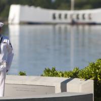 In memory: With the USS Arizona in the background, a Navy rifleman stands at attention at the ceremony commemorating the 72nd anniversary of the attack on Pearl Harbor on Saturday in Honolulu. Pearl Harbor ceremony marks bombing anniversary