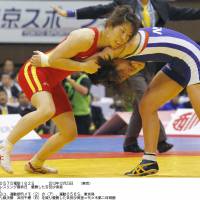 Still the best: Saori Yoshida (left) wins her 11th 55-kg title at nationals on Monday. | KYODO