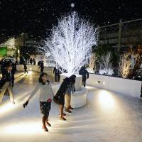 People skate on the first rooftop ice rink in the nation built on top of a department store after its opening Friday at Matsuya Ginza in Tokyo. The rink will close on March 2. | KYODO