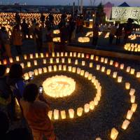 A total of 1,000 candles are lit Thursday in Ishinomaki, Miyagi Prefecture, to mark the 1,000th day since the 2011 quake and tsunami struck the Tohoku region. | KYODO