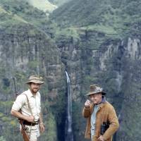 High adventure: Young Nic in the 1960s (left), during his time as Ethiopia\'s first-ever game warden, standing with John Bromley, a former British Consul to Eritrea, more than 3,000 meters up on the lip of Geech Abyss in the Simien Mountains, with the 800-meter Djinn Barr Falls plunging down behind them. | C.W. NICOL