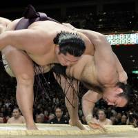 Muscular triumph: Endo overpowers Kotooshu on Friday at the New Year Grand Sumo Tournament, improving to 10-3.   | KYODO