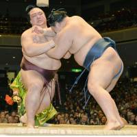 Strength on display: Ozeki Kisenosato (left) forces Goeido out of the raised ring on Wednesday at the New Year Grand Sumo Tournament. | KYODO