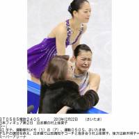 Differing emotions: Kanako Murakami is comforted by coach Machiko Yamada after her crucial performance in the short program at the Japan nationals, while Akiko Suzuki calmly takes the ice. | KYODO
