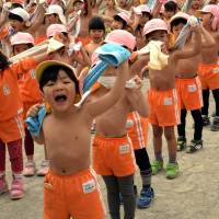 In the pink: Kids towel off after exercising at a playground at Tokyo\'s Mizuho Kindergarten on Monday, the day on traditional Japanese calendars recognized as \"daikan\" (major cold), or the chilliest day of the year. The 500 kindergartners play shirtless every day to stay healthy. | AFP-JIJI