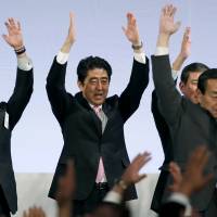 In the mood: Prime Minister Shinzo Abe and fellow Liberal Democratic Party members shout traditional “Banzai (long life)” cheers during the party’s annual convention at a hotel in Tokyo on Sunday. Abe: 'Numbers do not lie'
