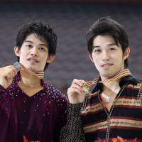 Stellar result: Silver medalist Takahiko Kozuka (left) and gold medalist Takahito Mura display their medals at the Four Continents Championships on Friday in Taipei. | AP