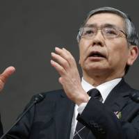 Liquidity overlord: Haruhiko Kuroda, governor of the Bank of Japan, gestures while making a speech to the Keidanren business lobby in Tokyo on Dec. 25. BOJ near limit for bond buys but boost may be needed
