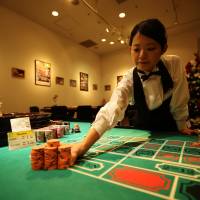 Place your bets: A dealer places chips on a roulette table at Casino Venus, a mock casino operated by Japan Casino School and Bright Inc. to simulate a real gambling experience, in the VenusFort shopping outlet in Tokyo on Dec. 3. | BLOOMBERG