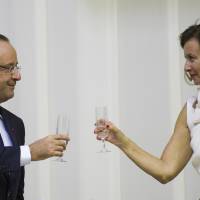 Sip and flit: French President Francois Hollande shares a toast with his partner, Valerie Trierweiler, at a state dinner with South African President Jacob Zuma in Pretoria last October. Once veiled, French affairs feed tabloids