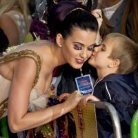 Out of fashion?: U.S. singer Katy Perry receives a kiss from a boy after he presented her with a bouquet of flowers on the red carpet at a central London cinema for the European premiere of her film “Part of Me” in July 2012. A pair of Perry’s false eyelashes have been added to an exhibit on cheap fashion at Britain’s Victoria and Albert Museum. Museum refuses to bat an eyelash with controversial new acquisitions