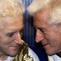 Look-alike: Jimmy Savile poses for a picture with his waxwork model at Madame Tussauds museum in London in December 1986. 'Damning' Savile review expected to reveal up to 1,000 cases of child abuse