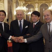 Equals four: Foreign Minister Fumio Kishida (left), his French counterpart, Laurent Fabius, Defence Minister Itsunori Onodera and his French counterpart, Jean-Yves le Drian, pose before a meeting in Paris on Thursday. | AP