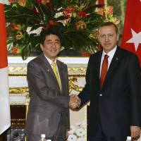 Economic dialogue: Turkish Prime Minister Recep Tayyip Erdogan is greeted by Prime Minister Shinzo Abe prior to their talks in Tokyo on Tuesday. | AP