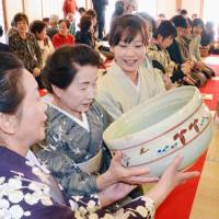 Women participate in the traditional first tea ceremony of the year at Saidaiji Temple in the city of Nara on Wednesday. The temple traditionally serves tea from a large bowl after a high-ranking monk named Eison began doling out tea to the public in January 1239 in an era when drinking the brew was a luxury. | KYODO