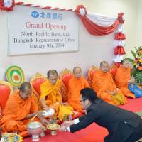 Monks hold a religious ceremony Thursday in Bangkok at the opening of a representative office of Sapporo-based North Pacific Bank. The regional bank launched the office to support firms from Hokkaido wishing to enter Thailand and other countries in the Association of Southeast Asian Nations. | KYODO