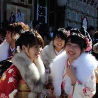 Kimono-clad women who will turn 20 this year chat after attending the Coming-of-Age Day ceremony at Asakusa Public Hall in Taito Ward, Tokyo, on Monday. | SATOKO KAWASAKI