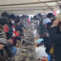 Diving in: Diners grill oysters at the Secchu Jumbo Kaki Matsuri in Anamizu. | VIOLA KAM