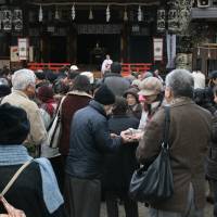 Watch the birdie: Visitors to Osaka Tenmangu Shrine swap bullfinch charms. | VIOLA KAM