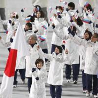 Members of Japan\'s Olympic team wave to the audience at the Fisht Olympic Stadium during the opening ceremony of the Sochi Winter Olympics. | KYODO