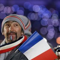 A member of the French team looks up during the 2014 Winter Olympics opening ceremony. | AP