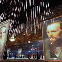 Performers stand next to giant portraits of famous Russian writers during the closing ceremony of the 2014 Winter Olympics. | AFP-JIJI
