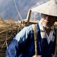 Working the land: Min Tanaka plays an old man living in the thick of nature in \"Iya Monogatari: Oku no Hito (The Tale of Iya).\" But his experience is different than that of his young adopted charge, and a man who moves to Shikoku\'s Iya Valley to escape city life. | ILLUSTRATION BY  BAMBI GOODMAN