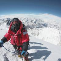 Sky high: Alpinist Yuichiro Miura poses for a photo on the summit of Mount Everest on May 23, 2013. Yuichiro Miura: on top of the world