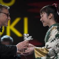 Kudos: Actress Haru Kuroki receives the Silver Bear for best actress at the 64th Berlin International Film Festival on Saturday, for her part in director Yoji Yamada\'s \"The Little House.\" The Berlinale, Europe\'s first major film festival of the year, ended Sunday. | AFP-JIJI