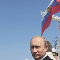 Russian President Vladimir Putin stands aboard a warship during a Navy Day ceremony in Sevastopol last July 28. | AFP-JIJI