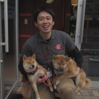 Puppy love: Chikao Muratani, owner and veterinarian at Anima Animal Hospital, is inspired by the innocence of his furry charges, such as these Shiba dogs. | JUDIT KAWAGUCHI