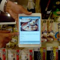 The main ingredients: A Sato Holdings official displays a bar code system that can display multilingual information on Japanese food products recently at Iwate Ginza Plaza in Tokyo\'s Ginza district. | SATO HOLDINGS