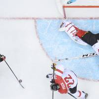 As cold as ice: Canada’s Jeff Carter skates in on Austria goalie Bernhard Starkbaum during their Olympic hockey game on Friday. Carter fuels blowout win