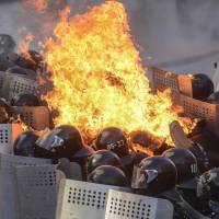 Molotov cocktails are hurled at riot police by demonstrators. | REUTERS
