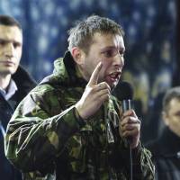 Volodymyr Parasiuk delivers an impassioned speech to a crowd of protesters as opposition leader Vitali Klitschko (left) looks on during a rally in Kiev on Friday night. | REUTERS