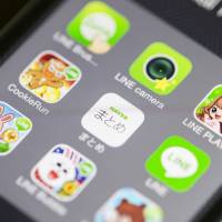 App icons for Line Corp.\'s Internet messaging and calling service, controlled by Naver Corp., are displayed in this arranged photograph on an Apple iPhone 5s in Hong Kong on Tuesday. | BLOOMBERG