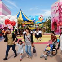 Families and students stroll in the Universal Studios Japan theme park in Osaka. | KYODO