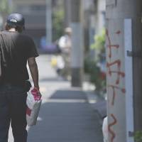 Falling behind: A man walks toward a labor and welfare center in Tokyo. As workers’ wages struggle to keep up with the recent surge in “bad inflation,” Prime Minister Shinzo Abe’s economic strategies face a litmus test, pundits say. Workers stumble while 'Abenomics' soars