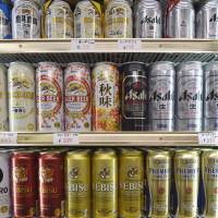 Cans of various beer brands produced by Kirin Brewery Co., Asahi Breweries Ltd. and Sapporo Breweries Ltd. are displayed last month in a liquor store in Kawasaki. 'Abenomics' no help to breweries