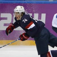 Hard knocks: T.J. Oshie of the United States falls to the ice after a challenge with Finland’s Sakari Salminen on Saturday. Finland routs U.S. to claim hockey bronze